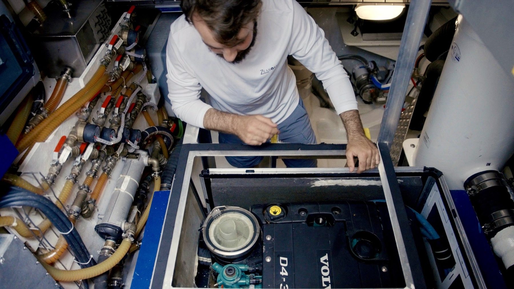 A ZeaFarer technician inspecting a yacht's engine bay during a scheduled visit.